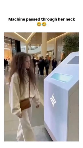 Thetrandlab48 on Instagram: "The post shares a 10-second AI-generated video illusion of a woman in a mall kiosk bending over a machine that seemingly threads a cylindrical arm through her neck unharmed, ending with her laughing in surprise. This clip draws from a December 2025 Instagram trend of futuristic hair-styling kiosks using AI to depict instant transformations like curling or coloring, highlighting optical tricks that mimic magic. Replies reveal viewer shock and humor, with many correctl