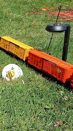 Menards 9631 Santa Fe hauls mixed freight load on the outdoor line past the "Bee Happy" stone TGIF