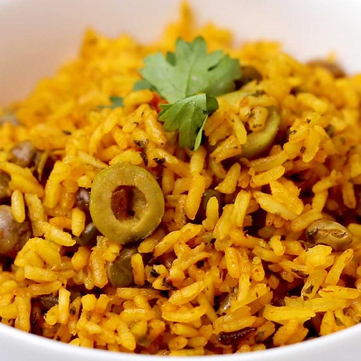 A traditional Puerto Rican dish, arroz con gandules is rice cooked with green pigeon peas. This orange-hued dish is full of flavor from the herby, peppery sofrito and pairs nicely with stewed chicken, pork, or red beans. Don’t worry if the bottom layer burns a bit as you finish cooking the rice--this crispy layer is called pegao and is one of the best parts of the dish! | Tasty