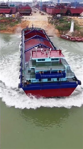 Launching a barge into the river