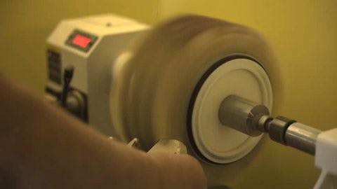 clip-4031396225-artisan-meticulously-forms-wooden-cog-using-precise