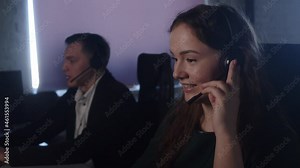 Technical Support Specialist With Headsets Working On Computer In Call Center Control Room Answers Incoming Calls Talk With Client Gives Professional Consultation To Customers Sell Company Product.