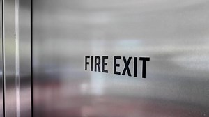 Fire exit sign in a modern building hallway