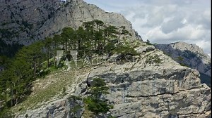 Two men hiking on top of a rocky mountain