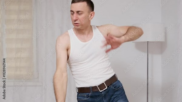 Dancing man showcases choreography in slow motion, highlighting graceful movements and rhythmic expression in a studio setting