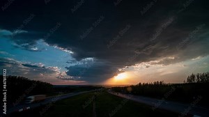 Time lapse over a major highway with an epic beautiful time lapse of clouds over that road from a bird's eye view, video loop