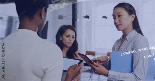 Three women using tablets right woman tapping and causing code overlay over faces reviewing IT data