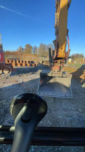 Operating a Yellow Excavator: A First-Person Perspective