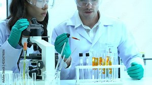 Scientists are experimenting with chemicals compound and absorb liquid the test tube. Concept of science, testing development and lab industry.