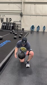 Hey, friends! I'm back with some helpful one-handed instructional content! 😂 This is how I do a medicine ball slam. I kneel down on one leg, roll the ball up to about the middle of my thigh, grab it with my left elbow and right hand as I move to a standing position, then raise it over my head and slam it down. During partner workouts where we're doing speed slams, working towards a certain number together, typically I will say double the number I've actually done since it takes me about twice a