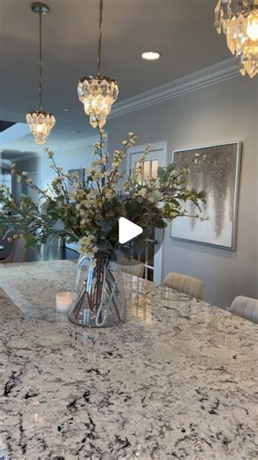 Dollhouse Interiors| Sharree on Instagram: "I just love a great floral moment🥰 And I love a clean kitchen…. Now if only it would stay this picture perfect😂! 🛍️Click the link in my bio to SHOP! #floraldesign #floralarrangement #springflorals #kitchen #spring #whitekitchen #largekitchenisland #granitecountertops #whiteicegranite #homeideas #floralideas #decor #homedecor #thewhitechallenge"
