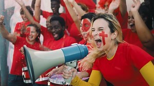 Female football fans exulting while watching a soccer game at the stadium - Women with painted face and megaphone encouraging their team - Sport entertainment concept