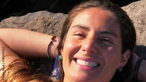 Cheerful Woman Lying On The Coastal Rock - Girl Sunbathing At Duranbah Beach - New South Wales, Australia. - high angle shot