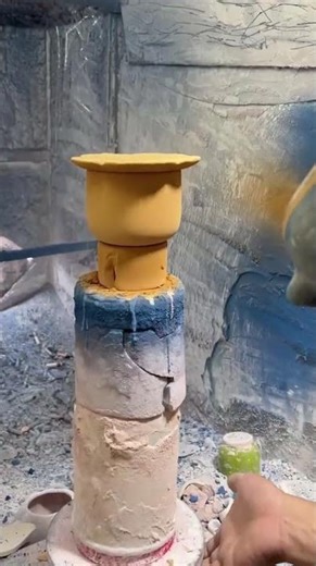the process of coloring cups using spray paint on a rotating machine