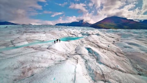 A vast green valley hidden beneath Alaska’s mountain clouds