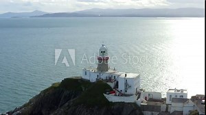 Baily Lighthouse, Howth, Dublin, Ireland, September 2021. Drone orbits from the east while gradually ascending revealing the view west across the bay towards the city, Dún Laoghaire and Killiney. Stock Video