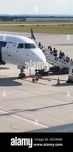Rzeszow, Poland - June, 15, 2023: Runway at the airport. People climb the ladder aboard the plane. Boarding a plane. There is equipment nearby for aircraft maintenance. Flights Stock Video Footage - Alamy