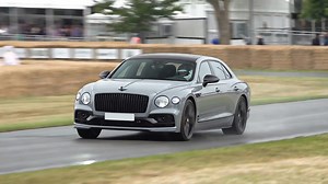 Bentley Flying Spur accelerates hard on a wet festival track