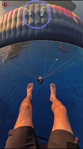 The paraglider forgets his slippers on the parachute.