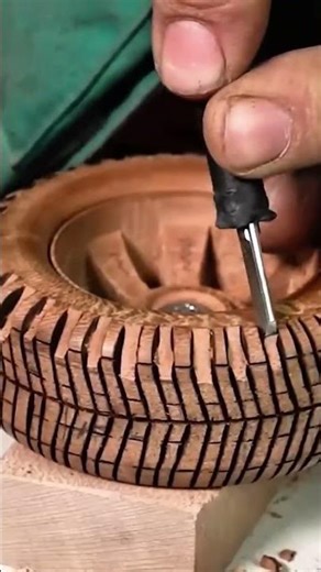 smoothing a round wooden object using sandpaper on a rotating machine for a professional wood finish