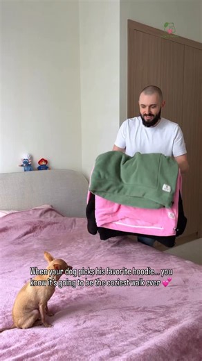 kokopaws | No-Sag Dog Sling & Hoodie Carrier on Instagram: "Our three bestselling kokopaws kangaroo hoodies — Olive, Pink, and Black Teddy — the trendiest colors of the season. I placed them all on the sofa, and Christian immediately ran over, rolling around in them, trying to cuddle into every one. Then he grabbed the pink sleeve with his little teeth and pulled it toward me like, “This one, Dad.” I put on the pink hoodie while he watched so patiently, then he flopped onto his back, tucked his 