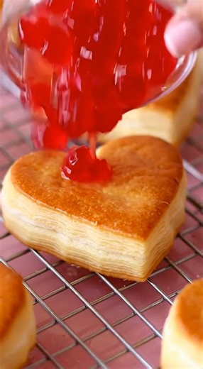Puff pastry hearts filled with cherry chip filling! They are a must for Valentine’s Day! This filling is so good and the flavors are so nostalgic!!🩷🍒 ➡️Comment VDAY and I’ll send you a dm with some of the items here! 🫶 Recipe🩷 The filling makes enough to fill 12 large pastries/hearts! 2 Puff pastry sheets 1 egg for egg wash Heat oven to 350. Use a heart cutter and cut out your shapes. Lay onto a cookie and brush with egg wash. Bake for 15-18 min or until golden brown. Allow to cool. Filling�