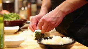 Medium Shot of Line Cook Preparing Sushi Rolls in Authentic Japanese Kitchen