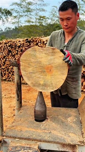Man lifting round log onto splitter, crisp rhythm of morning woodworking craft