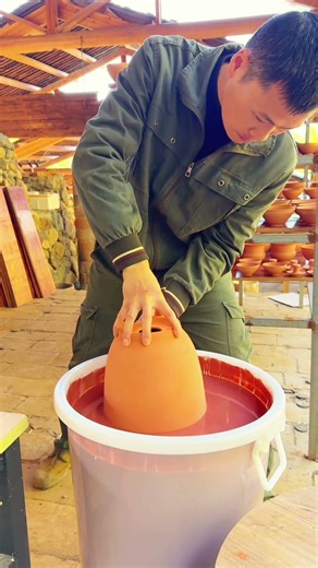 Pottery Glazing Technique: Dipping Clay Pots in Red Glaze
