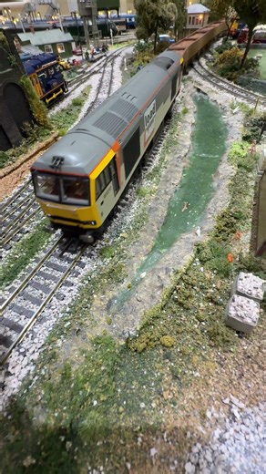 60070 pulling weathered mineral wagons past the stream.