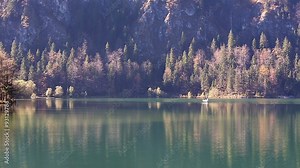 Fishing by the boat on the lake in the Alps