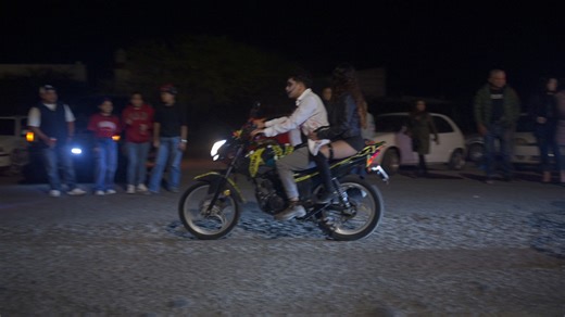 After dark on Dia de Muertos in Mexico, when the proper government celebrations are going on in Centro Square, the people make their own parade in the barrios. They show off tehir girls, they do wheelies (not advisable with two people FYI), they play music and dance. They put the entire family on a moped and ride around. Police generally stay away, because they are neither needed nor Welcome. | Gavin Seim