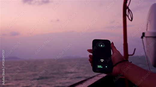 Hand Holding Smartphone Showing Starlink Connection Active Over Open Sea at Sunset Demonstrating Satellite Internet Access And Reliable Communication During Ocean Voyage