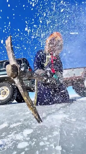 Breaking Ice on a Frozen Mongolian River for Animals