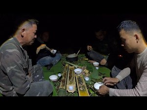 Setting up a makeshift shelter in the forest and sharing a meal of meat and wild vegetables with ...