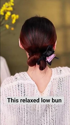 This relaxed low bun hairstyle is loose and voluminous,