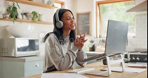 Laptop, headphones and video call with a woman entrepreneur in the kitchen of her home for small business. Computer, virtual meeting and a young freelance employee remote working from her house