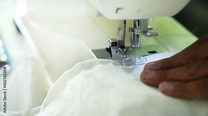 Seamstresses are sewing the mat.By using an automatic sewing machine.Tailoring is a task that uses Detail diligent patient.Sewing must be careful and slow motion not fast. sewing machine can help her.
