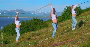 Three european women dance oriental dances on the bank of the estuary against the background of snow-capped mountains