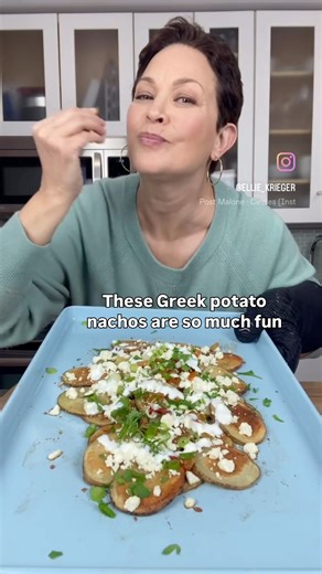 These are “nacho” average nachos! For this fun and healthy take, thinly sliced, crispy roasted potatoes stand in for the typical fried chips. They are piled with classic Greek flavors — feta cheese, herbs, hot cherry peppers and a yogurt-lemon drizzle with a whisper of garlic. I like to serve these Greek-ish Potato Nachos right on the sheet pan (with a clear “hot pan” warning!) for a fun, unexpected dinner. #PotatoNachos Get the recipe in the comment section. | Ellie Krieger