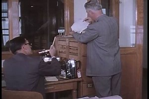 CIRCA 1950s - A police officer discusses a shoplifters crimes with another officer in the 1950s