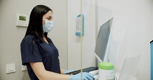 Female doctor examines and prepares the diagnostic machine in the hospital, and works on the computer and examines the tests. Diagnosis of breast cancer. Mammography device in a modern hospital.