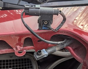 Passenger side washer nozzle hose popping off