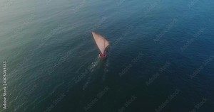 Traditional dhow sailboat sailing on the Indian ocean on the Swahili coast filmed with a drone, Tanzania.