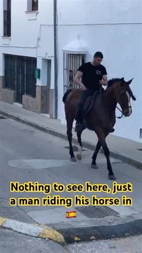 Man riding his horse through my Spanish village.