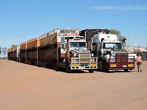Three Massive Road Trains pulling out onto Stuart Highway Australia.
