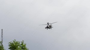 British army Boeing Apache Attack helicopter AH64E (AH-64E ArmyAir606) AH2 performing low level flight manoeuvres Stock Video