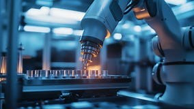 Industrial robotic arm performing precise tasks in advanced manufacturing facility during nighttime hours