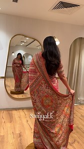 Wrapped in confidence, this bright red printed crepe designer saree tells a story of tradition with a modern heartbeat. The embroidered readymade blouse adds effortless elegance, making every moment feel festive. Bold, graceful, and unapologetically radiant, this look is made for celebrations, spotlight twirls, and unforgettable memories stitched in style. Where color meets confidence, heritage dances beautifully with today, always. | Samyakk Sarees