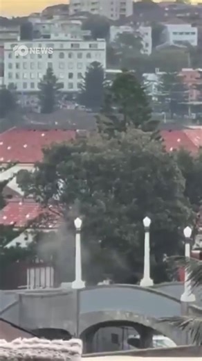 WARNING: GRAPHIC At least three people are dead in a shooting incident at Bondi Beach. Footage posted to social media shows crowds at Bondi running as multiple gunshots ring out. Additional footage appears to show two gunmen firing from a bridge overlooking the beach. NSW Police are urging people at the scene to remain in shelter. More to come. | 10 News Sydney